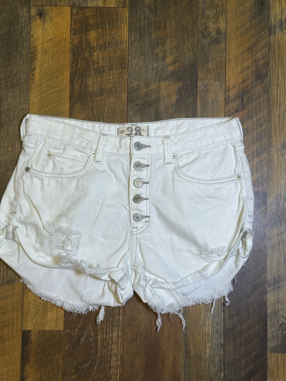 We the Free distressed button-fly white denim shorts size 28
